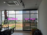 Black 5% openness sunscreen roller blinds installed on office windows by Bosita Decor Supply 