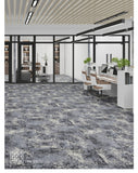 PaintSQ team installing grey carpet tiles in a office