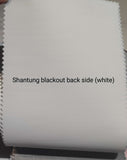 Shantung blackout roller blinds with white backing, showing the white reverse side of the fabric